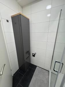 a shower stall with a glass door in a bathroom at RUEHOME in Essen +11 photos