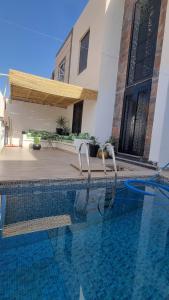 a swimming pool in front of a house at villa pools bbq lounge in Oujda
