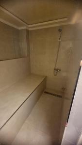 a small bathroom with a shower in a room at villa pools bbq lounge in Oujda +20 photos