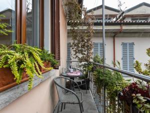 a balcony with a table and chairs and plants at Apartment near Lake Maggiore and Borromean Isles in Intra
