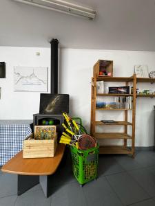 a room with a table with a basket and a shelf at ALBERGUE DE LASTUR in Deba