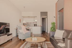 a living room with a couch and a table at Zuiderzee State - Appartementen in Makkum