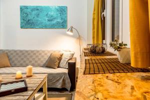 a living room with a couch and a table at Downtown Central Suite with Private Parking in Kalamata