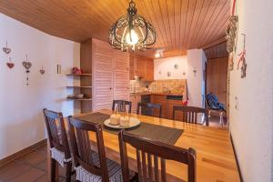 a dining room and kitchen with a table and chairs at Duplexwohnung in den Alpen in Riederalp