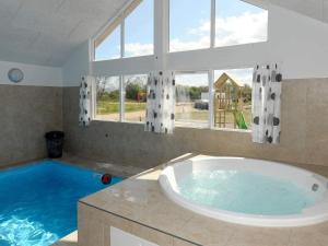 a large bathroom with a tub and a large window at Luxury Pool Retreat in Nordborg - By Traum Ferienwohnungen in Nordborg