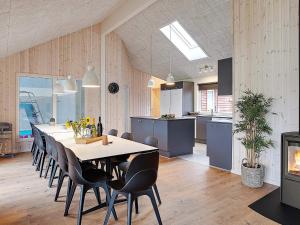 a kitchen and dining room with a long table and chairs at 5 star holiday home in Grenaa in Grenå