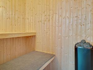 a room with a blue trash can in a wooden wall at 5 star holiday home in Grenaa in Grenå