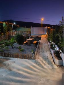 a garden at night with a bench and a table at Casa el pinar in La Orotava +7 photos