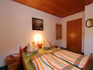 a bedroom with a bed and a wooden ceiling at Apartment Sulzau near Wildkogel Ski Slopes in Neukirchen am Großvenediger