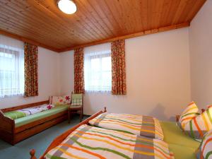 a bedroom with a bed and a couch at Apartment Sulzau near Wildkogel Ski Slopes in Neukirchen am Großvenediger +31 photos