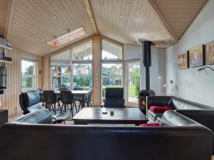 a living room with leather furniture and a table at 8 person holiday home in Rødby-By Traum in Rødby