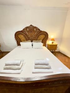 a large bed with white towels on it at Davit's Apartments 21 in Tbilisi City +28 photos