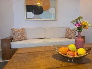 a bowl of fruit on a table with a couch at Andriana Luxury in Antananarivo