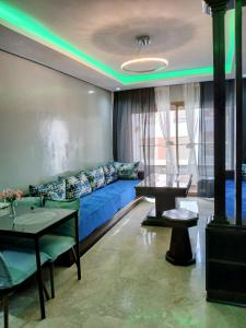 a living room with a blue couch and a table at Beachside Apartment in Mohammedia