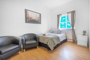 Ένα ή περισσότερα κρεβάτια σε δωμάτιο στο Houston Gardens