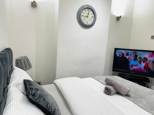 a bedroom with a teddy bear sitting on a bed with a tv at Large 'n' bright House in Middlesbrough +7 photos