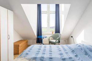 a bedroom with a bed and a window at Sünnslag Wohnung 129 in Boltenhagen +27 photos