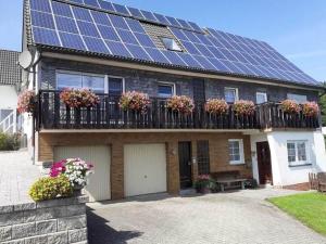 a house with solar panels on the roof at Gemütliche Wohnung für 4 Personen in Medebach +31 photos