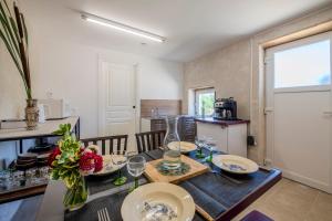 a kitchen and dining room with a table with wine glasses at Yourte mongole insolite en pleine nature in Pouilly-sous-Charlieu