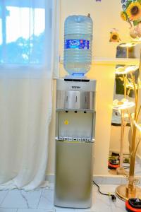 a bottle of water sitting on top of a refrigerator at Le Cristal de Roche in Pointe-Noire
