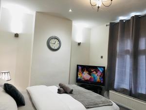 a bedroom with a teddy bear laying on a bed at Large 'n' Bright Room in Middlesbrough