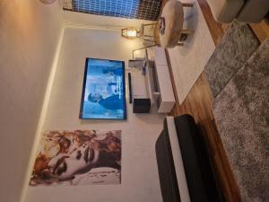a hallway with two pictures on the walls of a room at Relax in Lahtis Cozy Apartment in Lahti