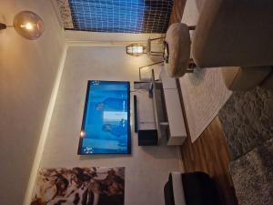 a room with a large screen television on a wall at Relax in Lahtis Cozy Apartment in Lahti