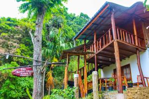 a wooden house with a tree in front of it at Bamboo Cabana Ella by Hill crest in Ella +19 photos