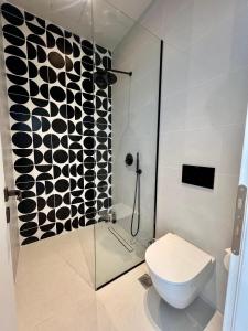 a bathroom with a toilet and a glass shower at Avia in Corfu