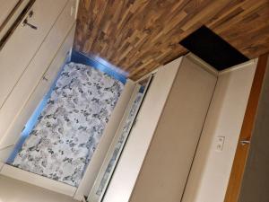 a small room with a ceiling with wood at Relax in Lahtis Cozy Apartment in Lahti +2 photos