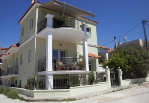 a white house with a balcony at Oasis in Nafplio