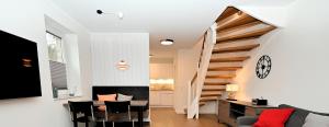 a living room with a staircase and a table and chairs at Möwenweg Die Möwe im Möwenweg App 1 in Hohwacht
