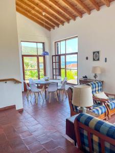 a living room with a table and chairs at Casa dos Magalhães in Vila do Porto