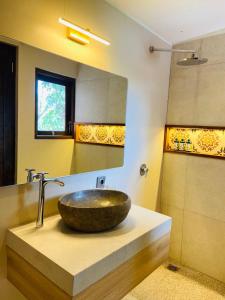 a bathroom with a bowl sink on a counter at PARAWIYA Villa in Munduk +23 photos