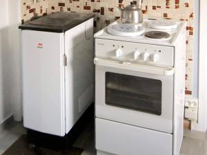 a white stove and a refrigerator in a kitchen at 6 person holiday home in Storsteinnes in Storsteinnes +14 photos