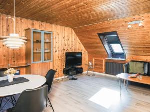 a living room with a table and a tv in a room at Tranquil Haven in Ansager - By Traum Ferienwohnungen in Ansager