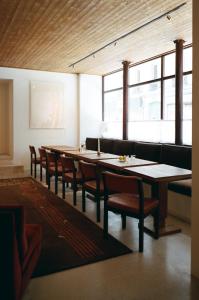 a dining room with a long table and chairs at Hôtel Massé in Paris