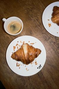 a piece of food on a plate on a table at Hôtel Massé in Paris +65 photos