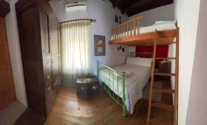 a bedroom with a bunk bed and a ladder at Morea Bay View in Tourlotí