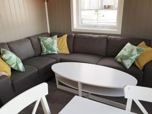 a living room with a couch and a table at 4 star holiday home in Oksvoll in Oksvoll
