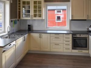 a kitchen with white cabinets and a sink at 6 person holiday home in Oksvoll in Oksvoll