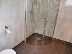 a shower with a glass door in a bathroom at 6 person holiday home in Oksvoll in Oksvoll