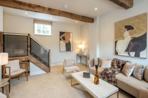 a living room with a couch and a table at The Granary - Elegant Countryside Retreat in Welford