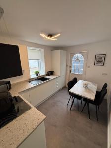 a kitchen and dining room with a table and chairs at Harbour View, Buchanhaven, Peterhead in Peterhead