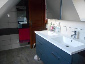 a bathroom with a white sink and a mirror at Gîte De Keraman, Charmante Maison in Plouézec +9 photos