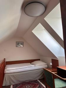 a bedroom with a bed in the attic at Apartman Reduta in Lučenec