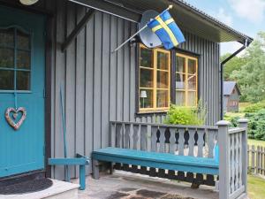 a house with a bench and a flag on it at 5 person holiday home in ASKERÖARNA-By Traum in Buvik