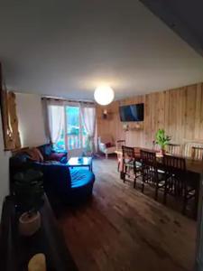 a living room with a couch and a dining room at Mountain View 3 Bedroom Apartment Saint Beat Lez in Saint-Béat