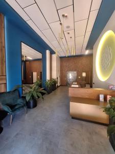 an office lobby with blue walls and potted plants at Апартаменти біля моря in Odesa +3 photos