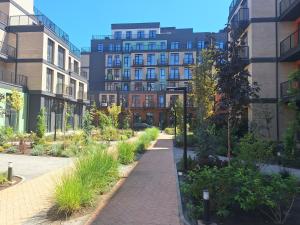 a walkway in a city with buildings and plants at Апартаменти біля моря in Odesa